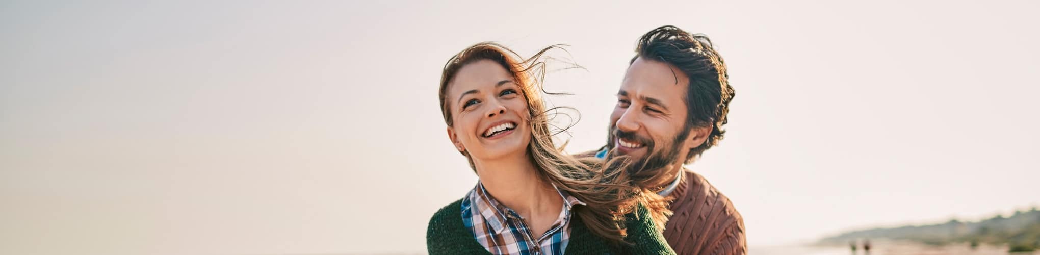 Smiling couple embracing outdoors after couples counseling